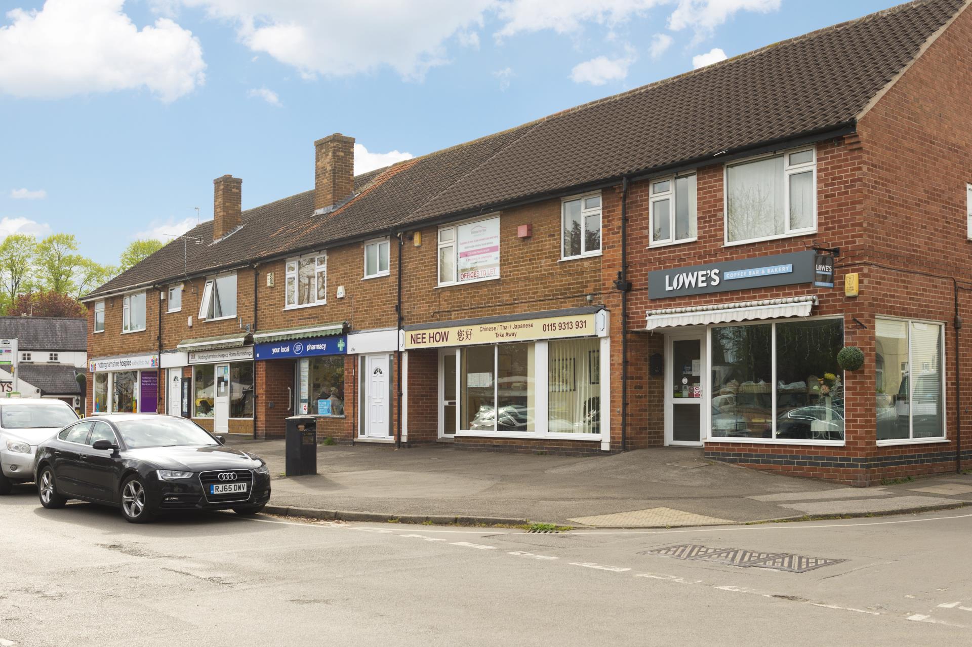 a brick building with a car parked in front
