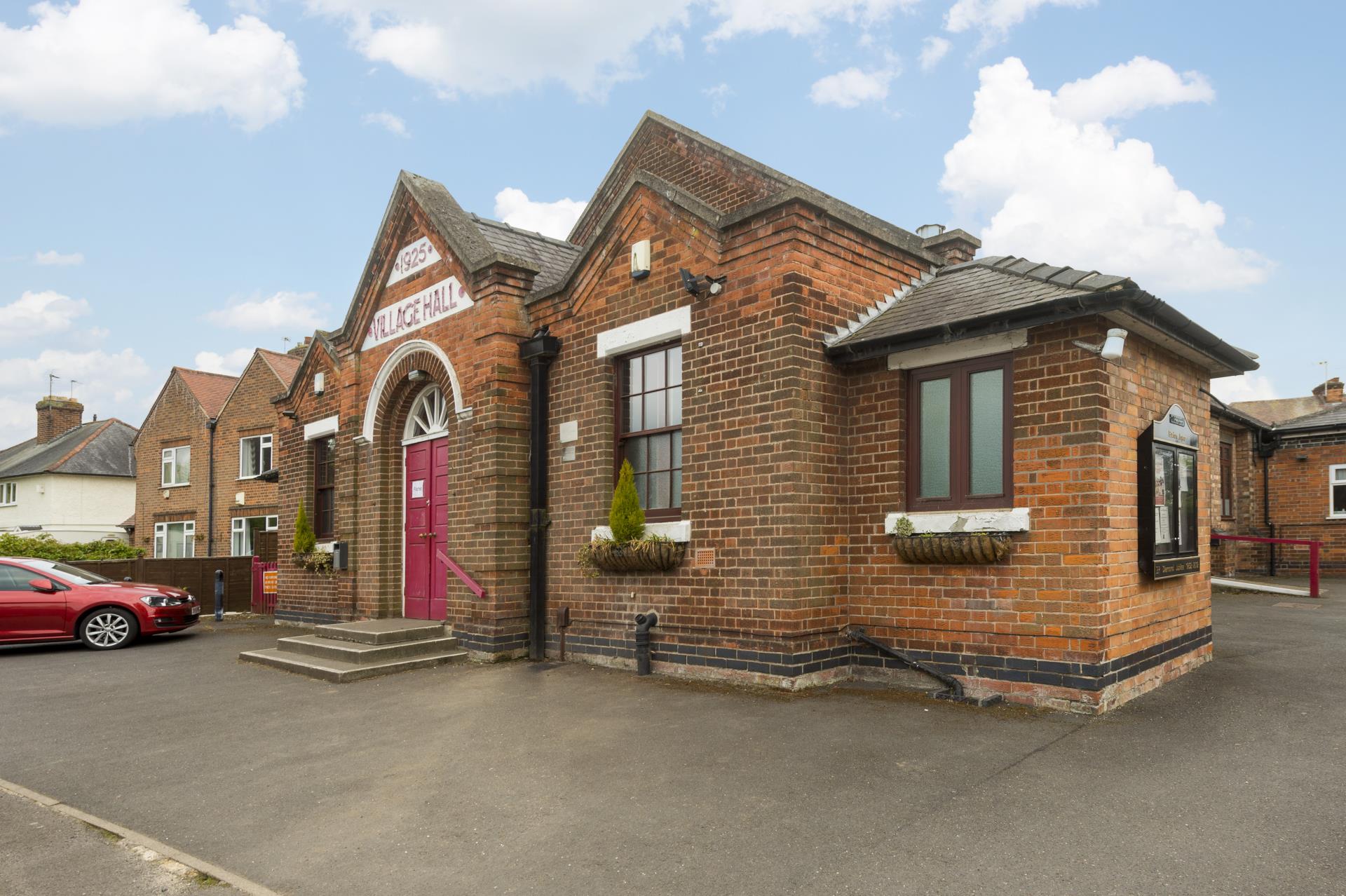 a brick building with a red door