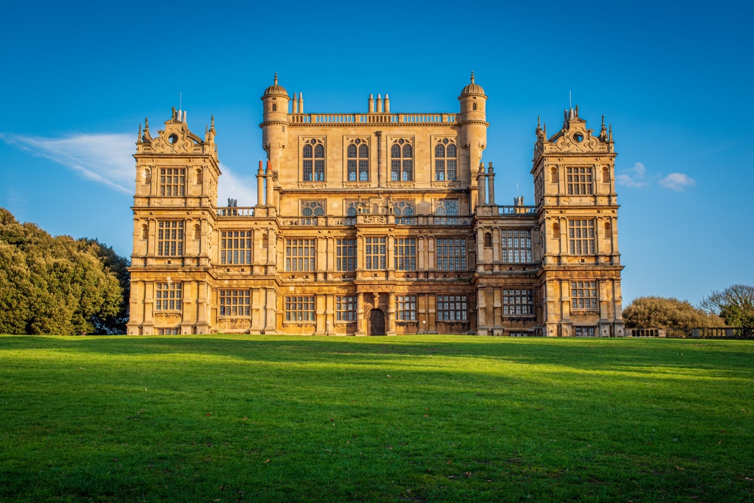A lush green lawn in front of Wollaton Hall in Nottingham.