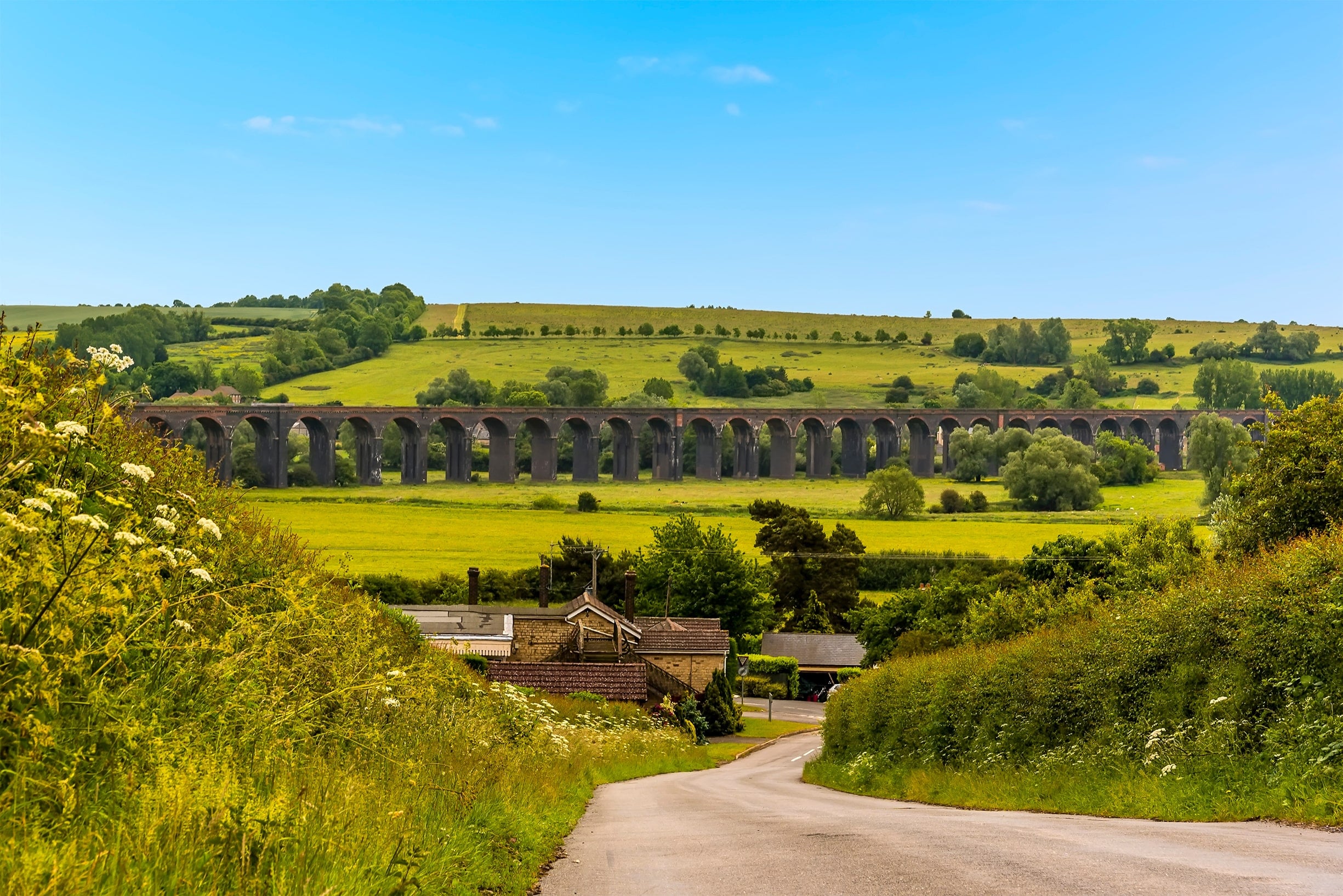 a bridge over a grassy field
