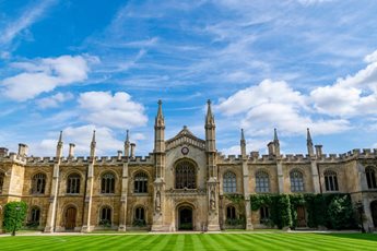 A green lawn in front of a historic Cambridge University building in Cambridgeshire.
