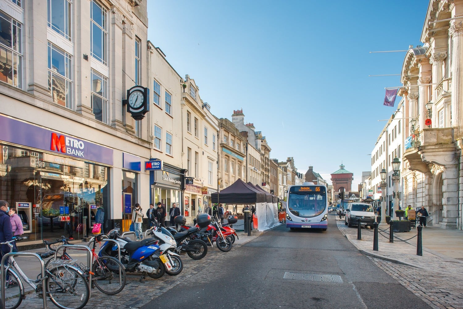 A bus and Metro Bank on a busy high street in Colchester.