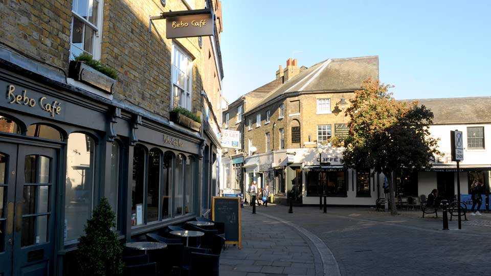 a street with buildings and people