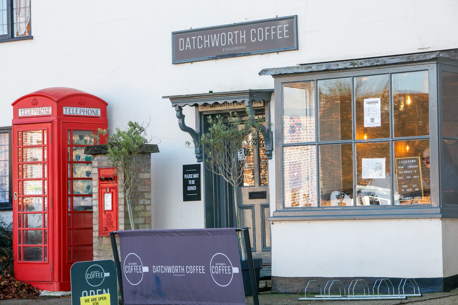 A photo of Datchworth Coffee, a cafe in Knebworth, with a red telephone box outside.
