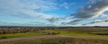 a large open field with a few buildings in it