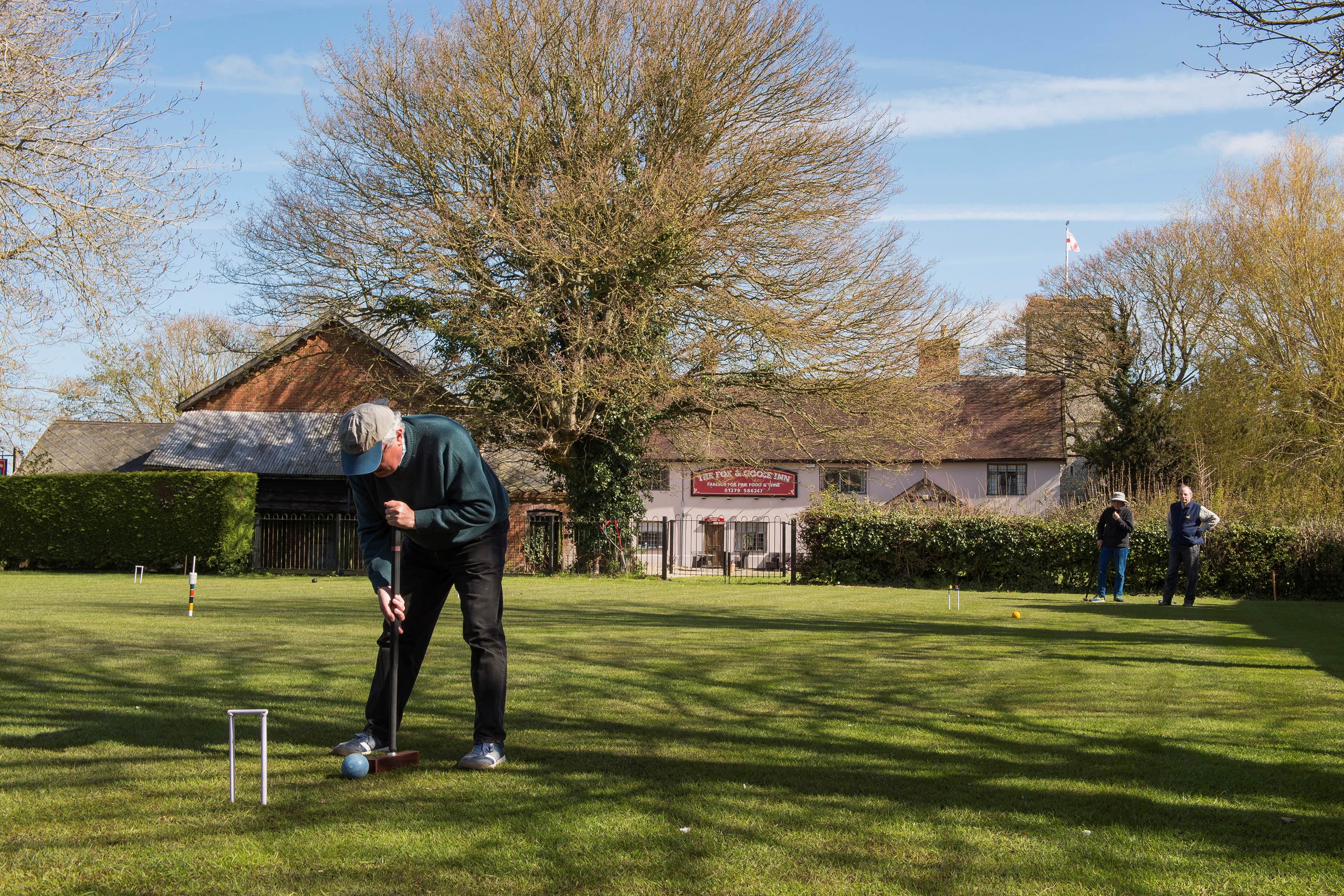 A retiree playing croquet at Fressington near Harleton, Norfolk