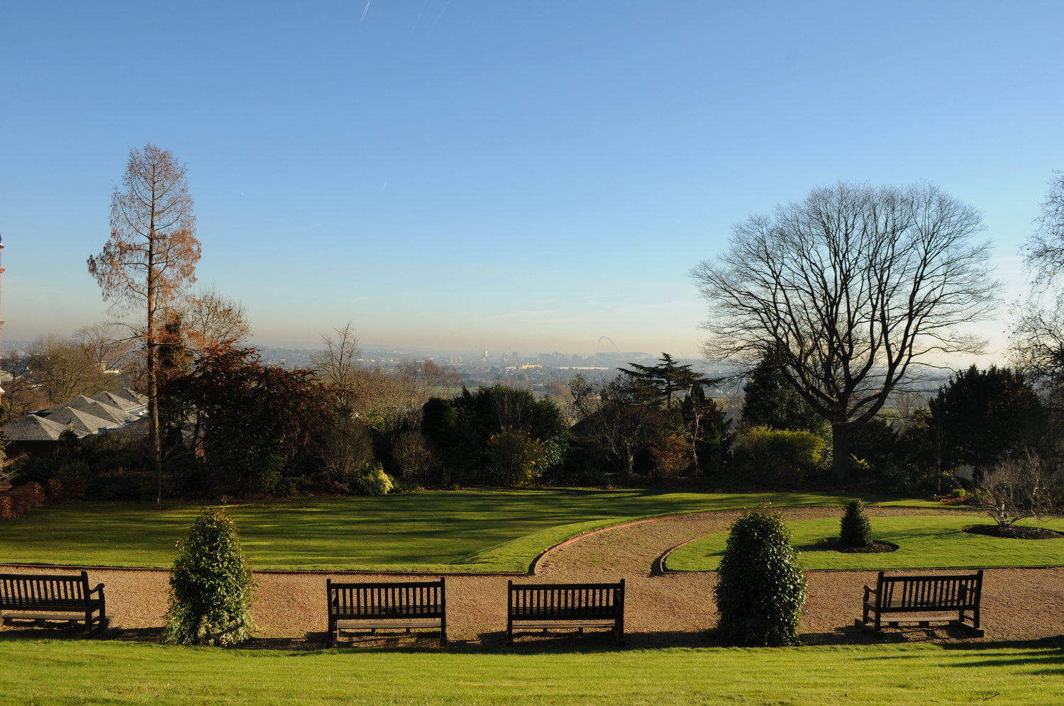A hint of the London skyline from the green grounds of Harrow School.
