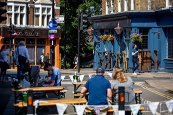people sitting outside near pub