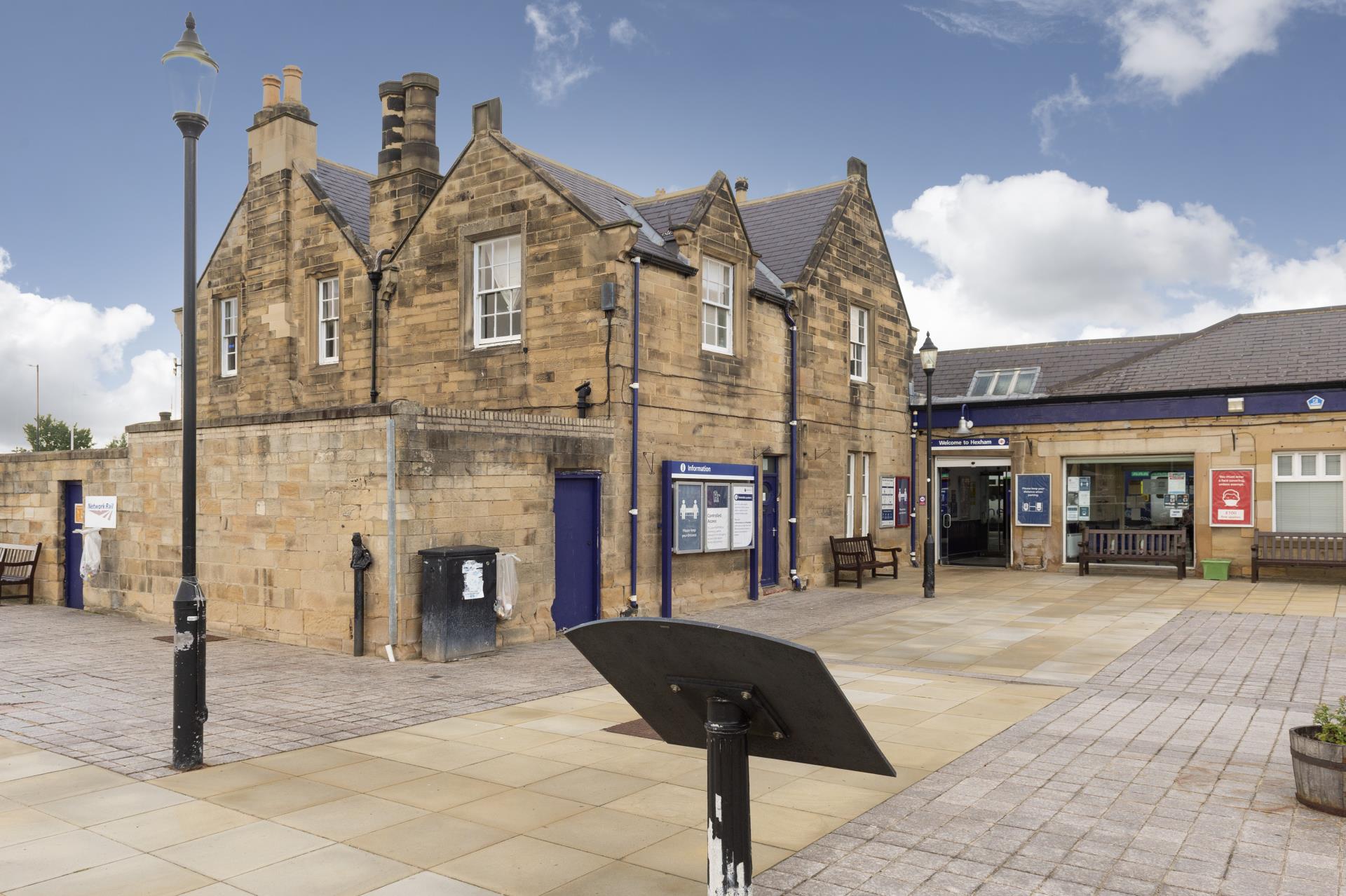 a brick building with a black umbrella