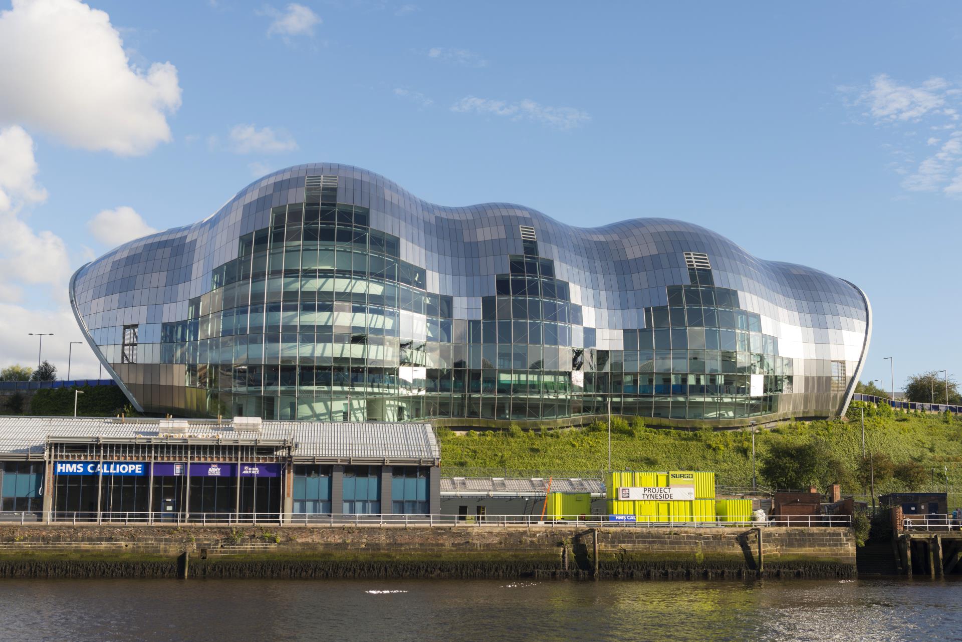 a large building with a glass roof with Sage Gateshead in the background