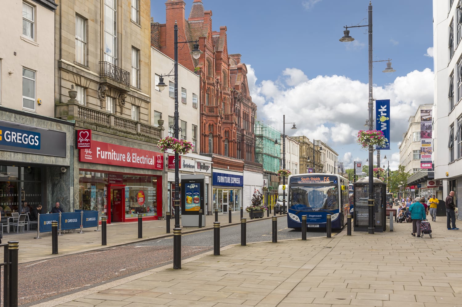 A street in Sunderland with shops and a bus.