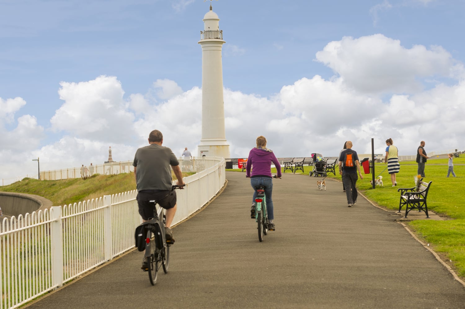 A group of walkers and cyclists on a popular trail towards Meik's Lighthouse in Sunderland.