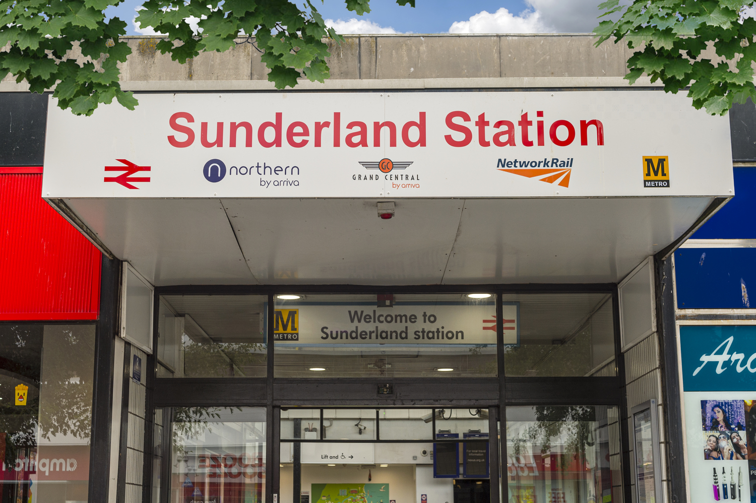 A photo of Sunderland Train Station, with logos of various train companies below the name.