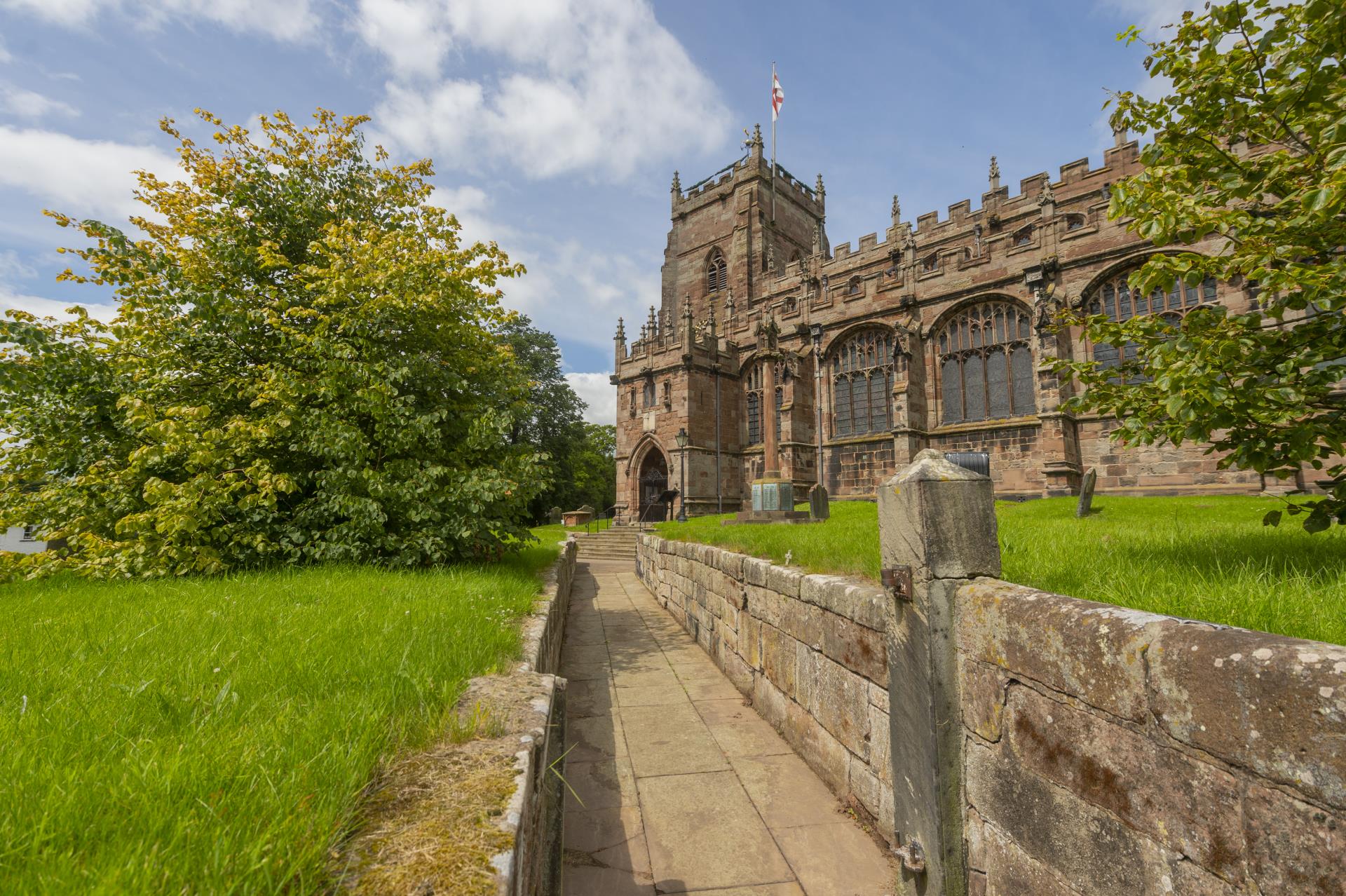 a stone wall leading to a castle