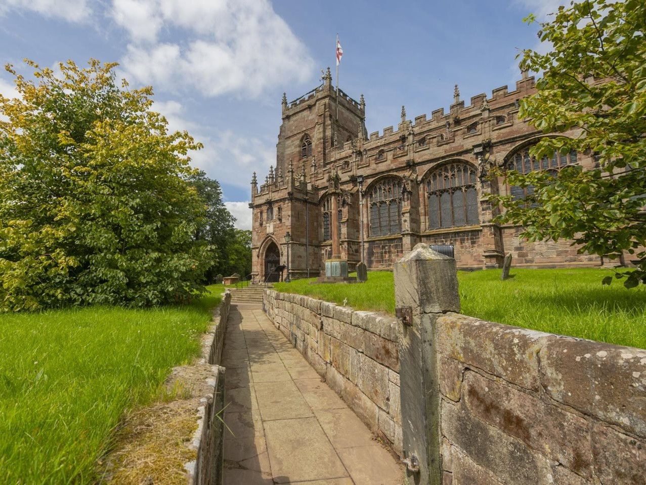 a stone wall leading to a building