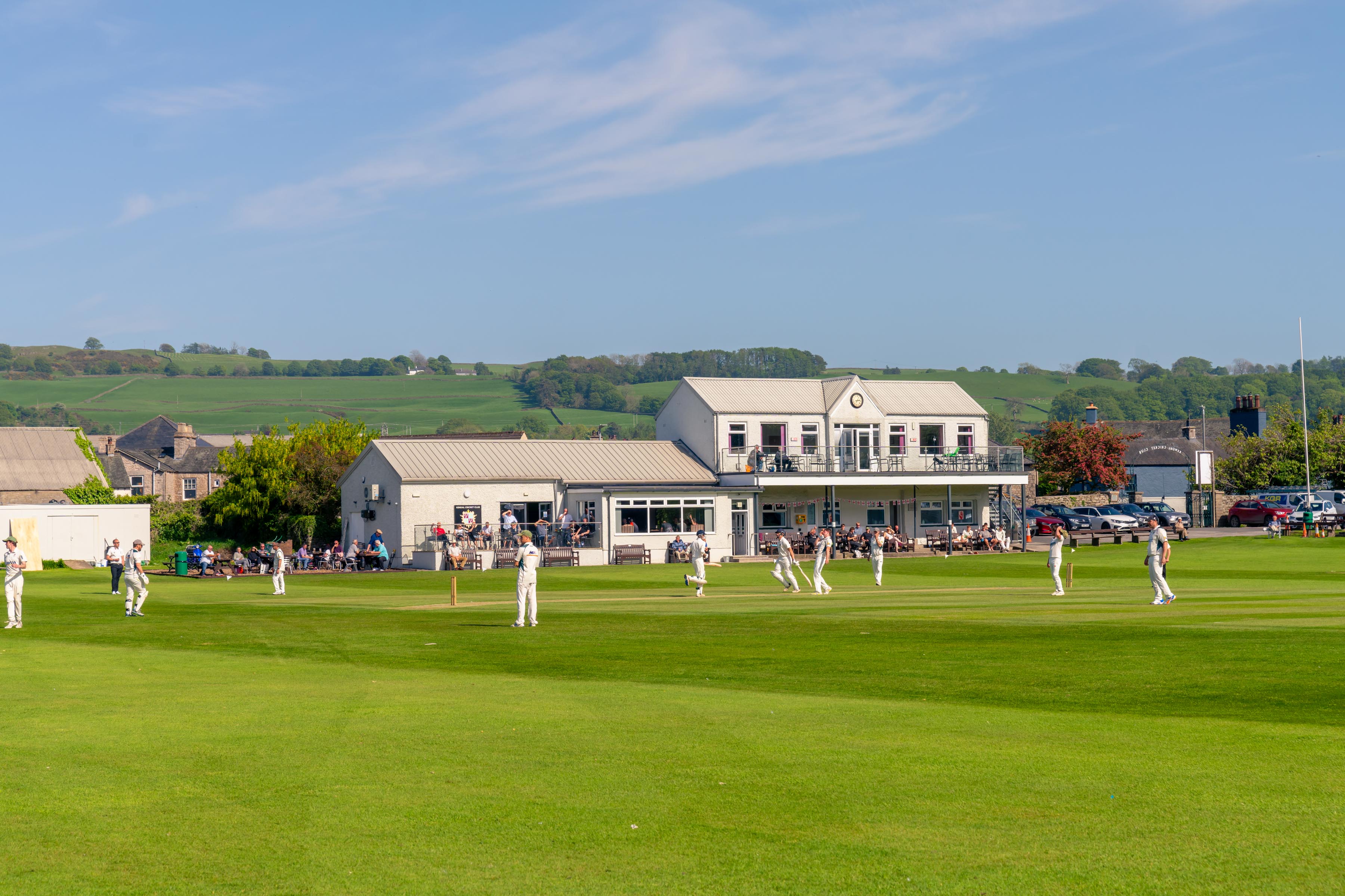a group of people playing cricket
