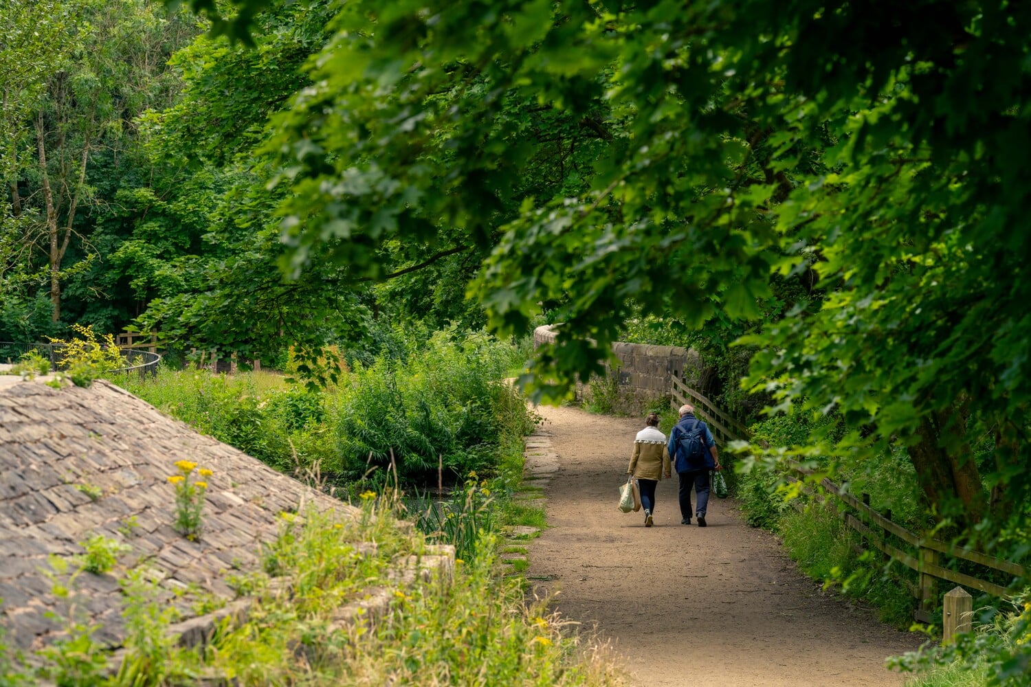Two retirees enjoy a walk through Daisy Nook Country Park.