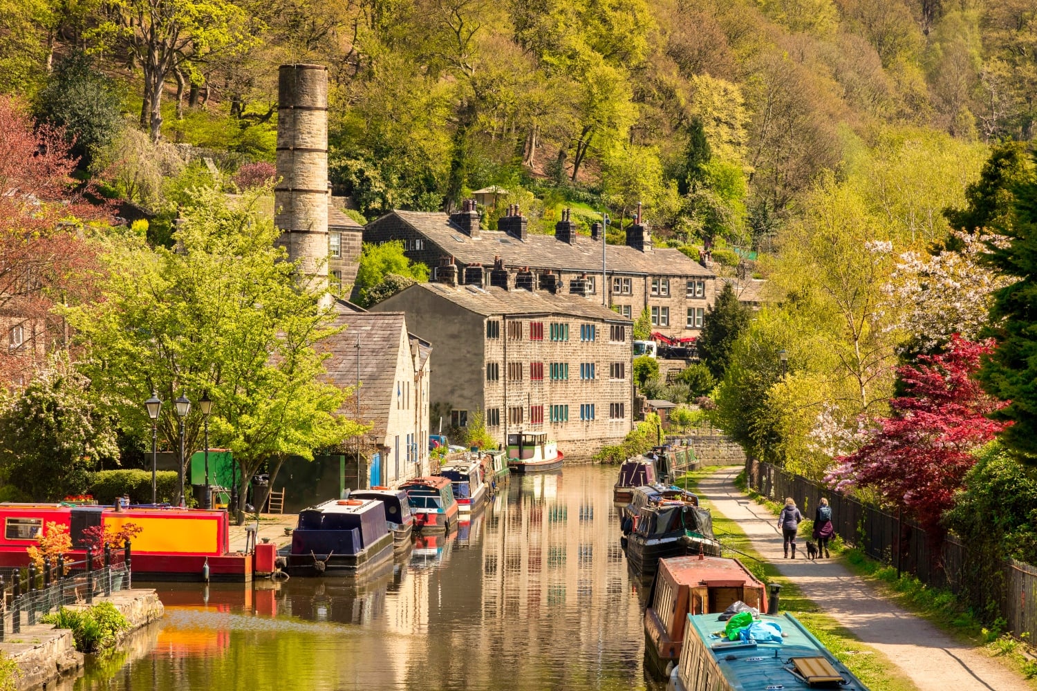 The Rochdale Canal lined with boats in Hebden Bridge.