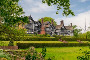 View from a lawn of Bramall Hall Tudor manor house.