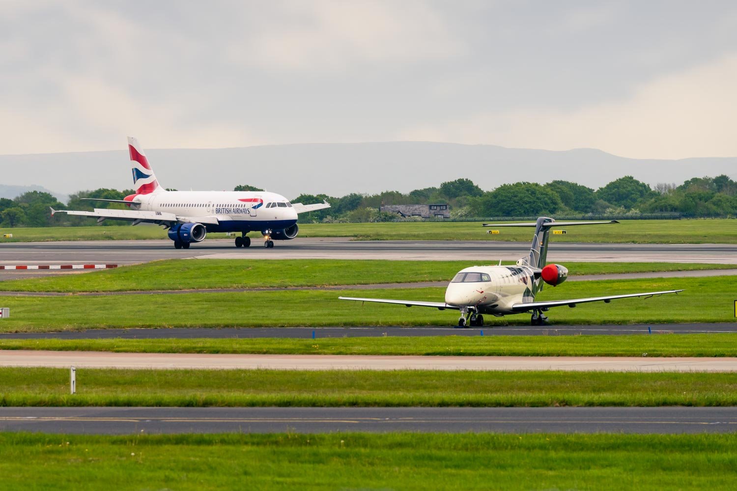 a couple of airplanes on a runway