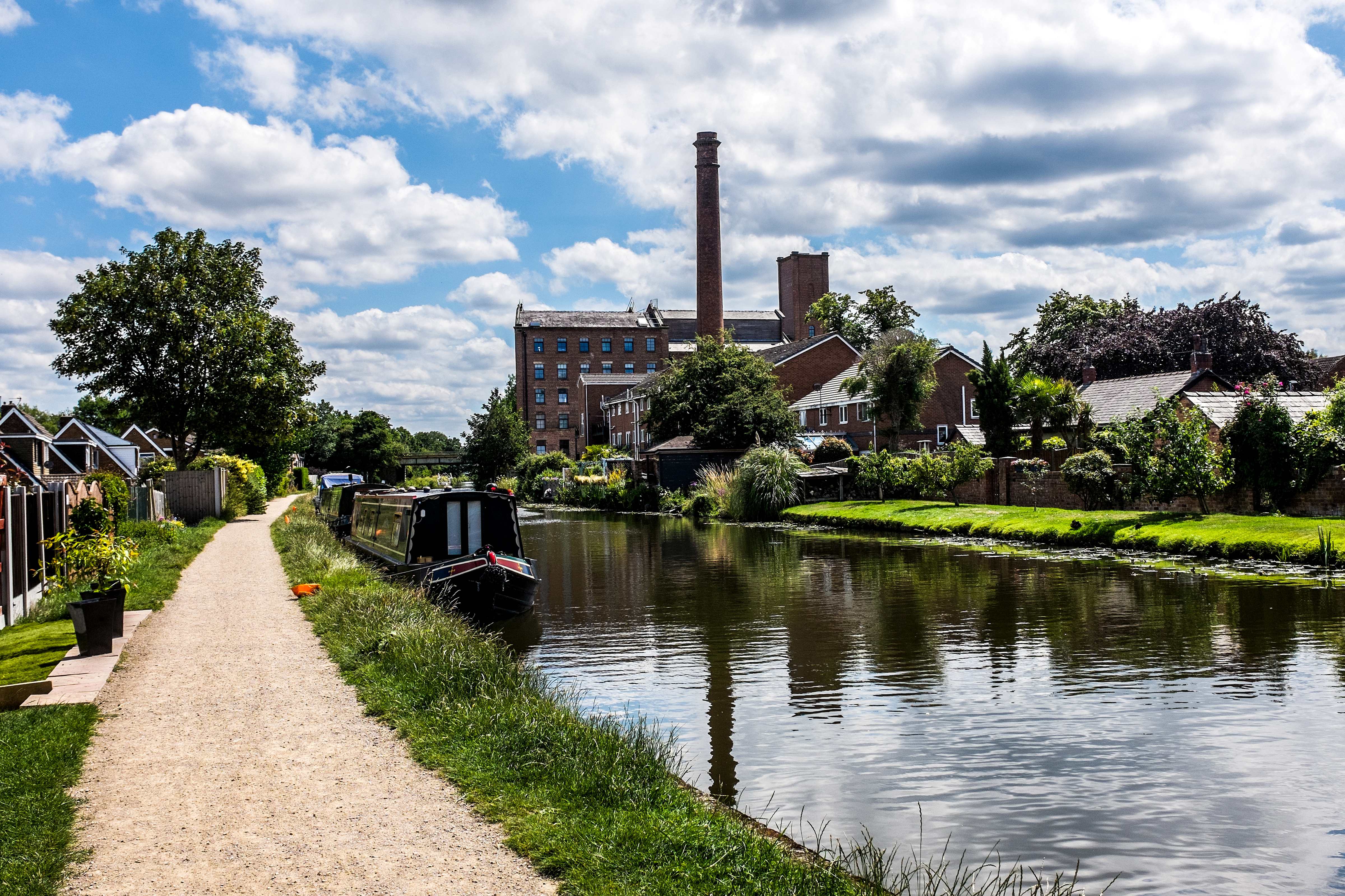 Canel with a boat and buildings along it in Burscough, Lancashire, England.