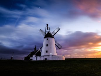a white building with a windmill