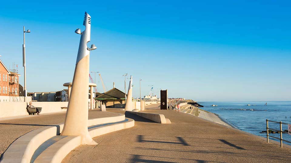 a walkway next to a beach