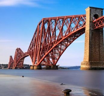 a large red bridge with Forth Bridge in the background