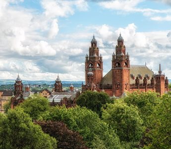 a large building with towers and trees in front of it with Mainz Cathedral in the background