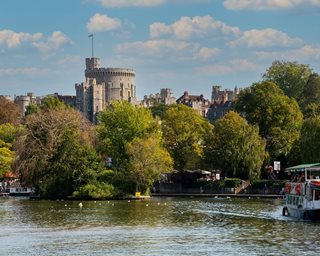 a body of water with trees and buildings in the background