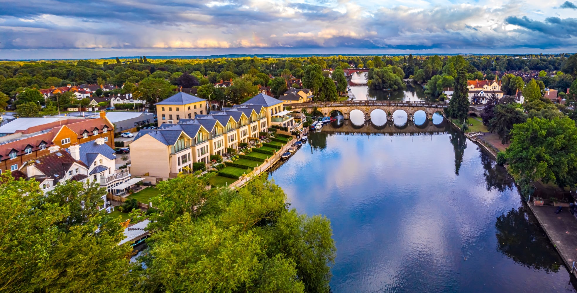 Aerial view of the River Thames and Maidenhead Bridge, buildings and surrounding greenery in Maidenhead.
