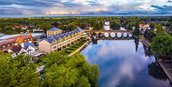 Aerial view of the River Thames and Maidenhead Bridge, buildings and surrounding greenery in Maidenhead.