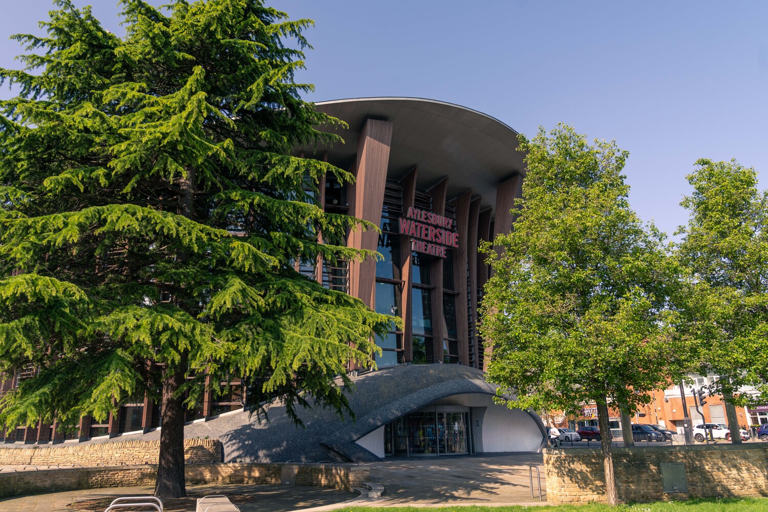 Aylesbury’s Waterside Theatre, surrounded by trees in summer.