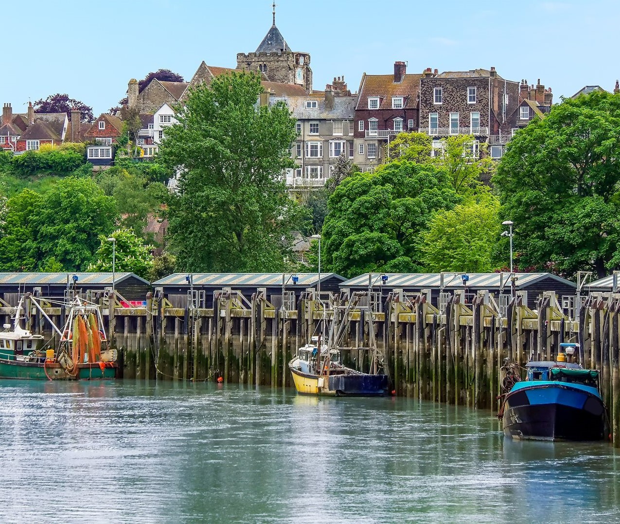 A row of fishing boats docked along the river in Rye.