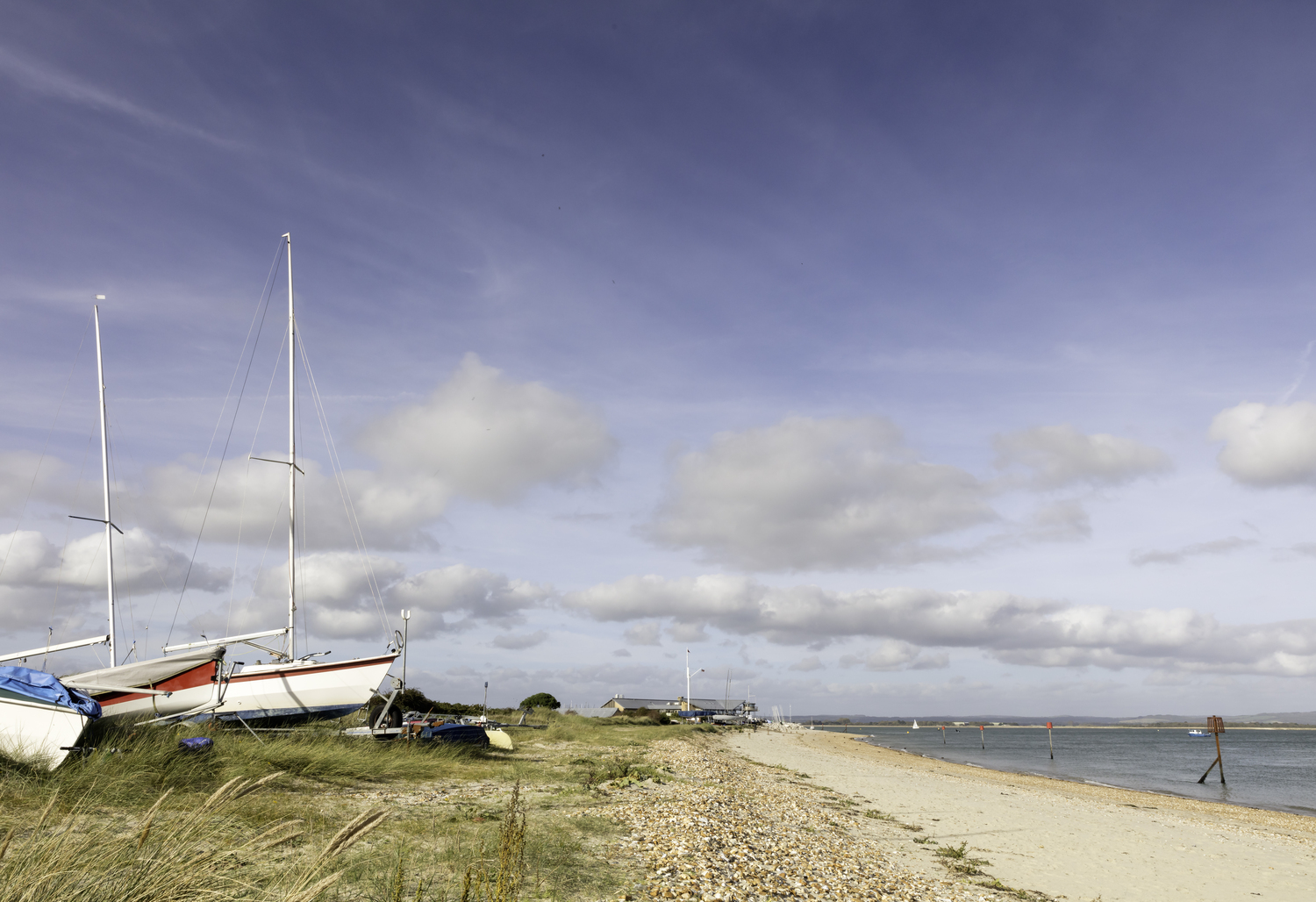 Sailing boats along the shoreline on Hayling Island, near Portsmouth.