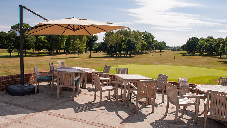 a patio with tables and chairs