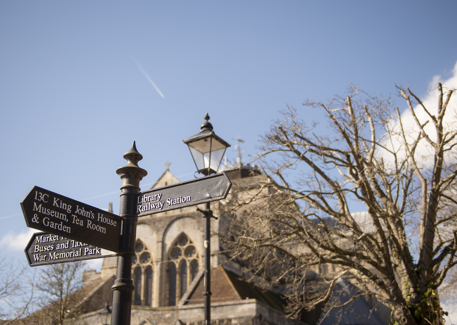 Signpost in Romsey showing directions to local amenities, attractions, and transport hubs