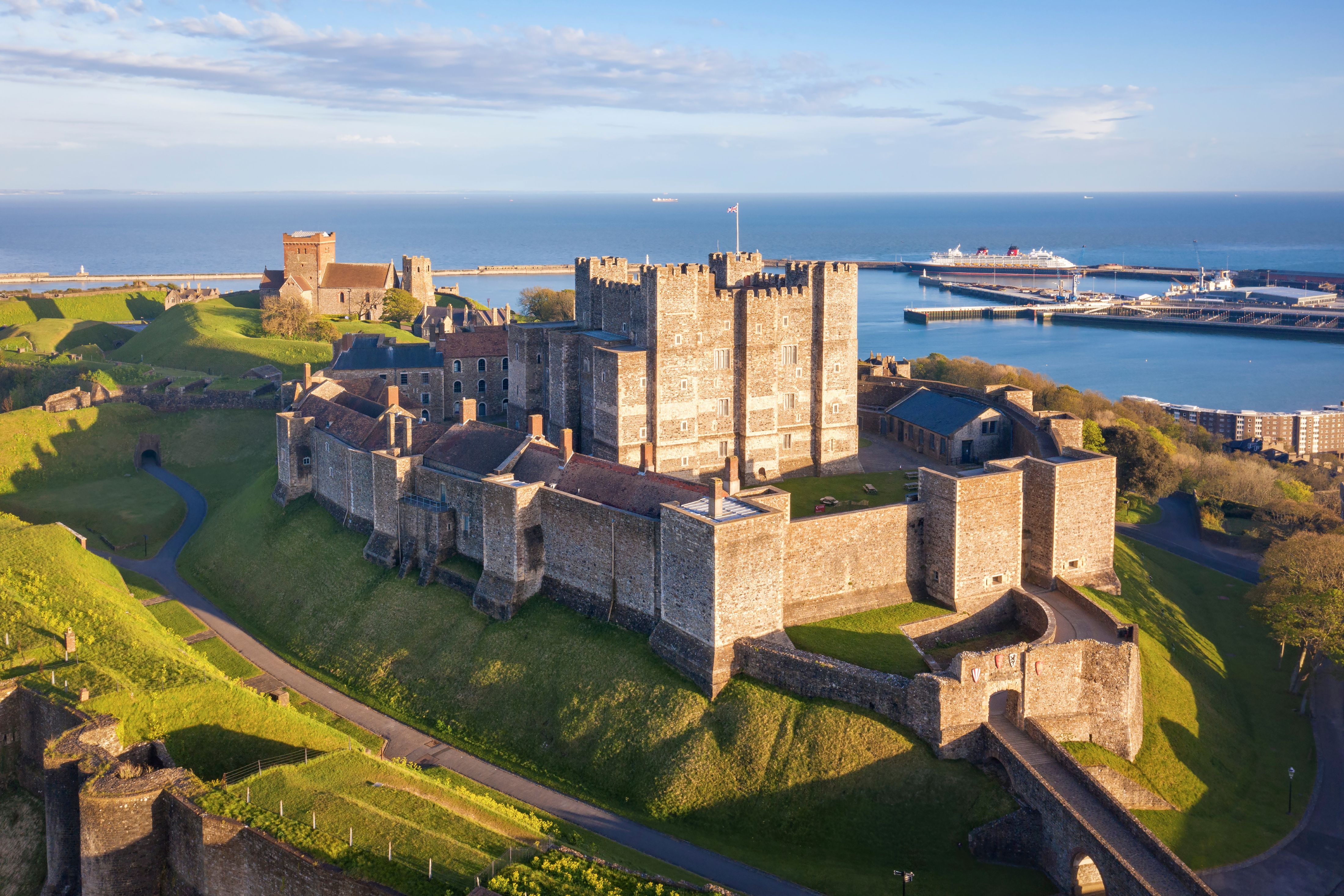 Dover Castle on a hill with the sea in the background.