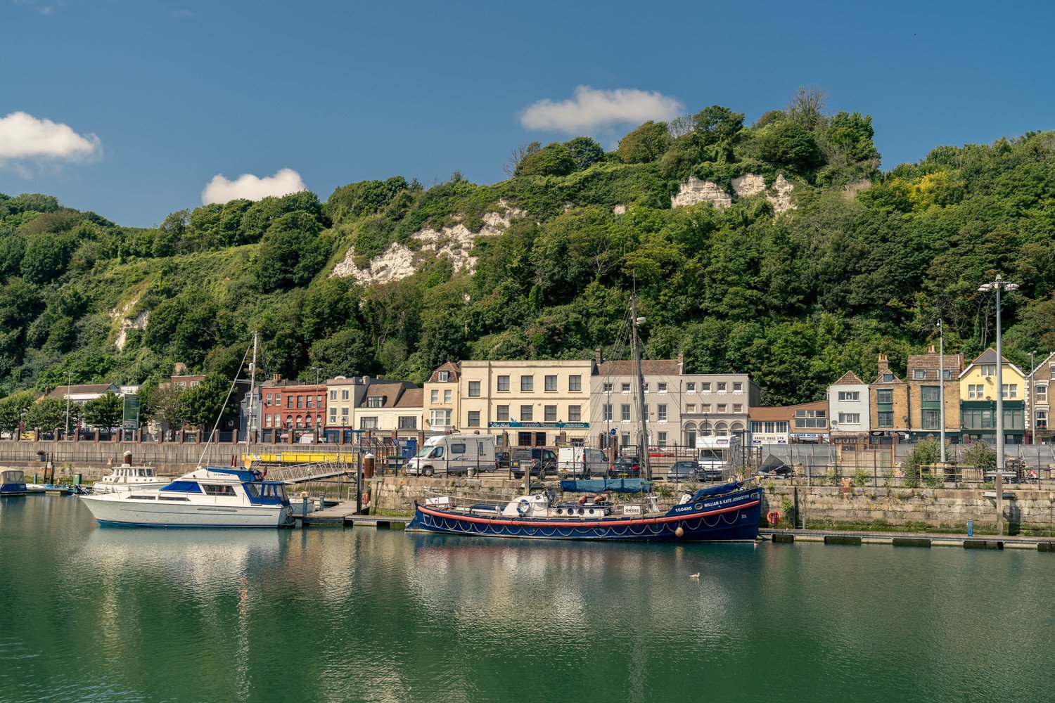 Boats in front of buildings and cliffs in Dover, Kent.