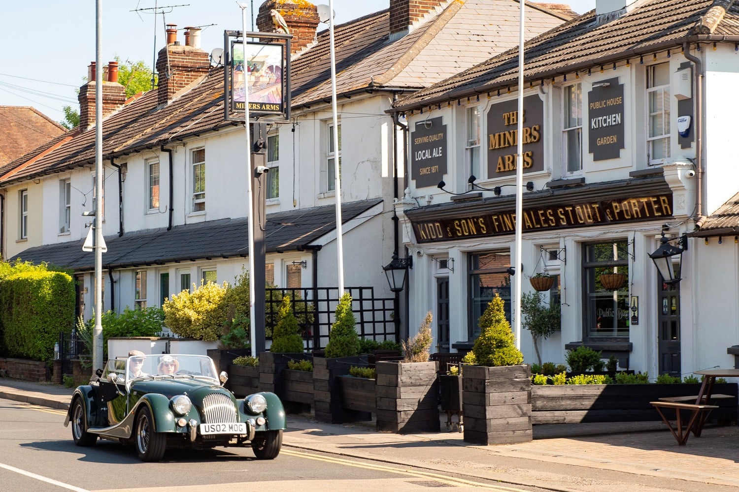 A retired couple sit in their classic car outside The Miners Arms pub in Dunton Green.