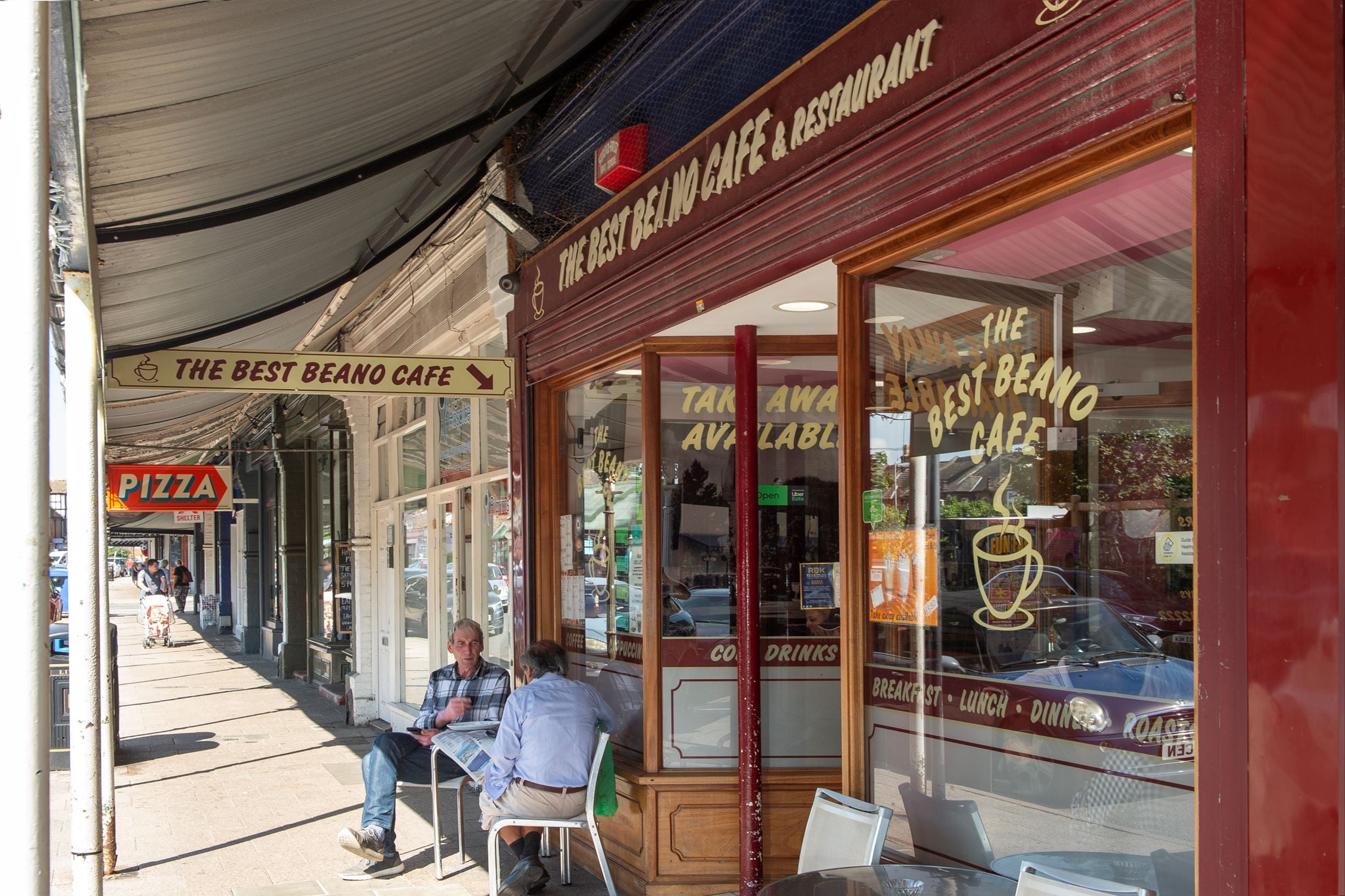 people sitting at a table outside a restaurant