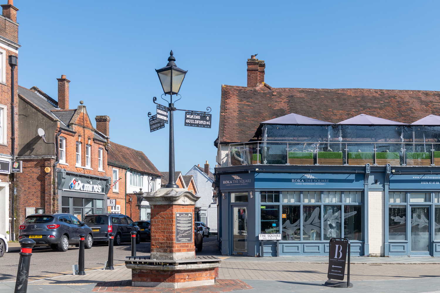 A view of Bagshot town centre with restaurants in the background.