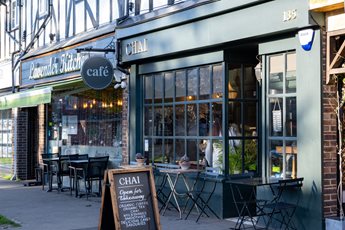 a restaurant with tables and chairs outside