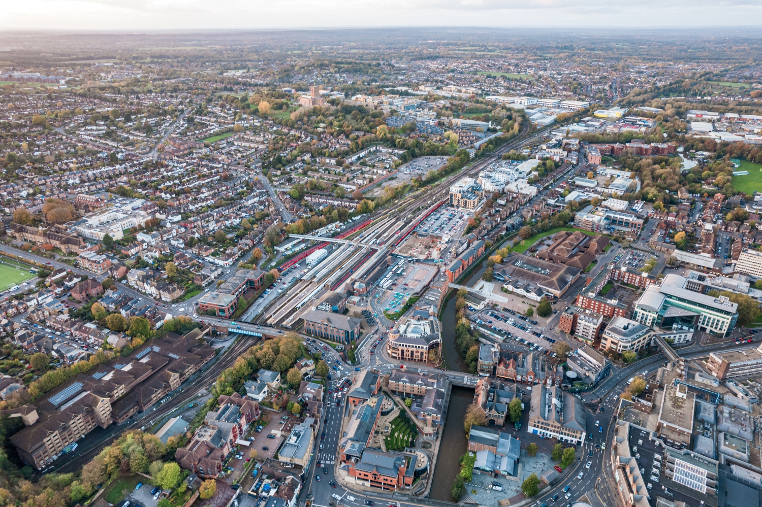 Aerial view of Guildford town centre and railway station, highlighting the town's excellent transport connections and local amenities.