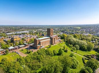 Aerial view of Guildford Cathedral overlooking Guildford town centre and the surrounding Surrey countryside.