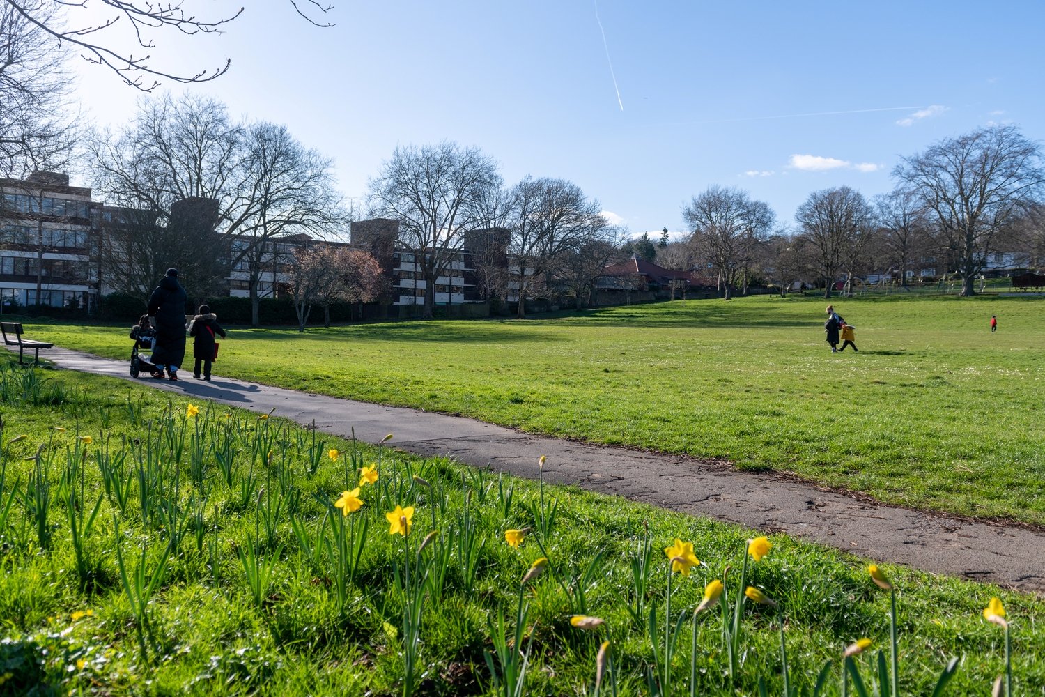 A local park close to Purley town centre with a group of people walking.