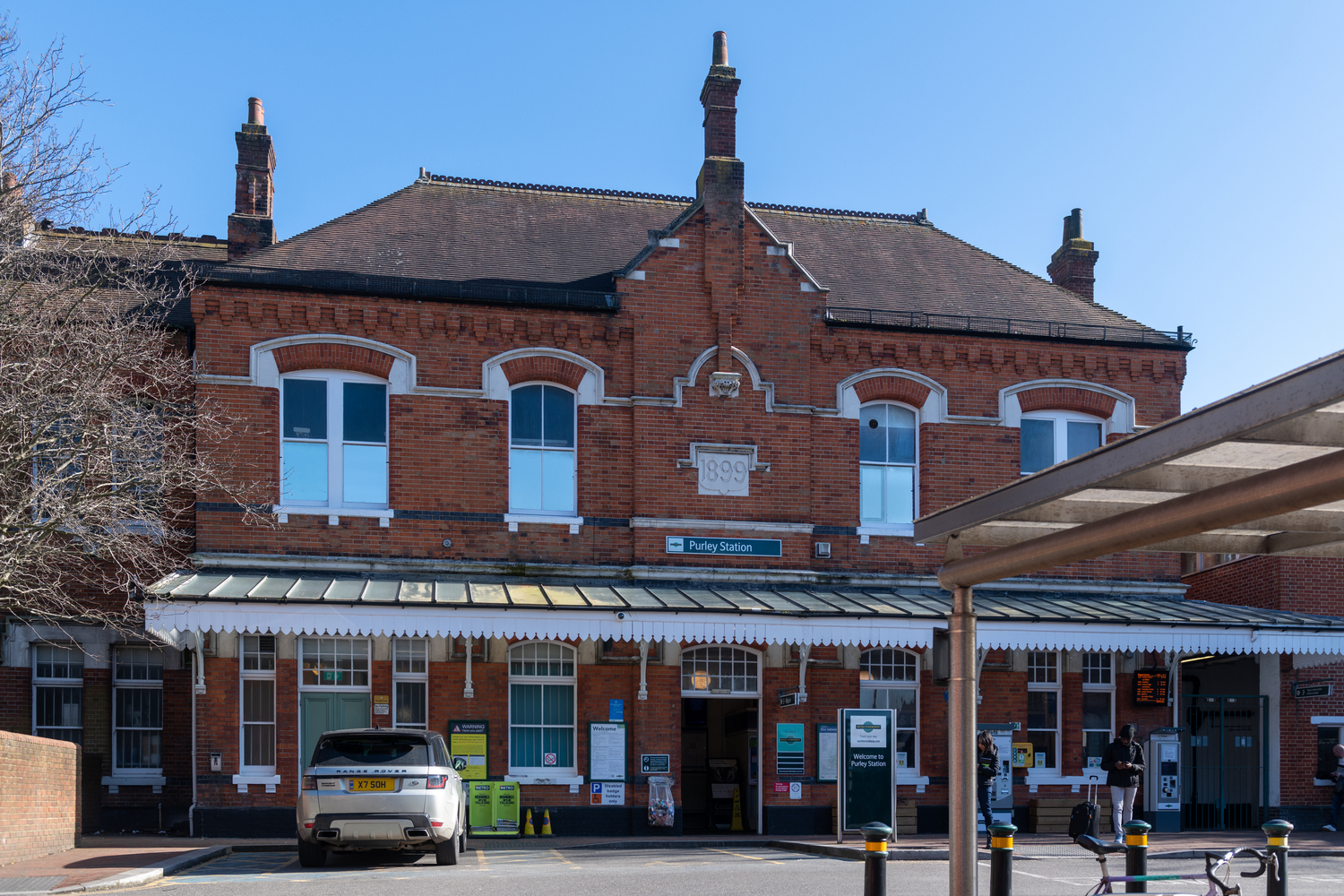 Red-brick exterior of Purley Station where people can catch trains to other towns and cities.