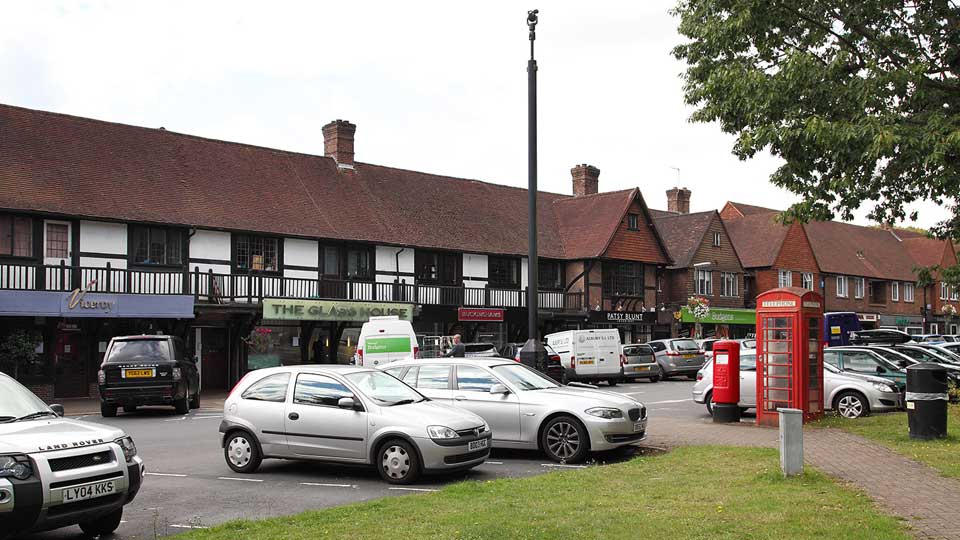 a parking lot with cars and a telephone booth
