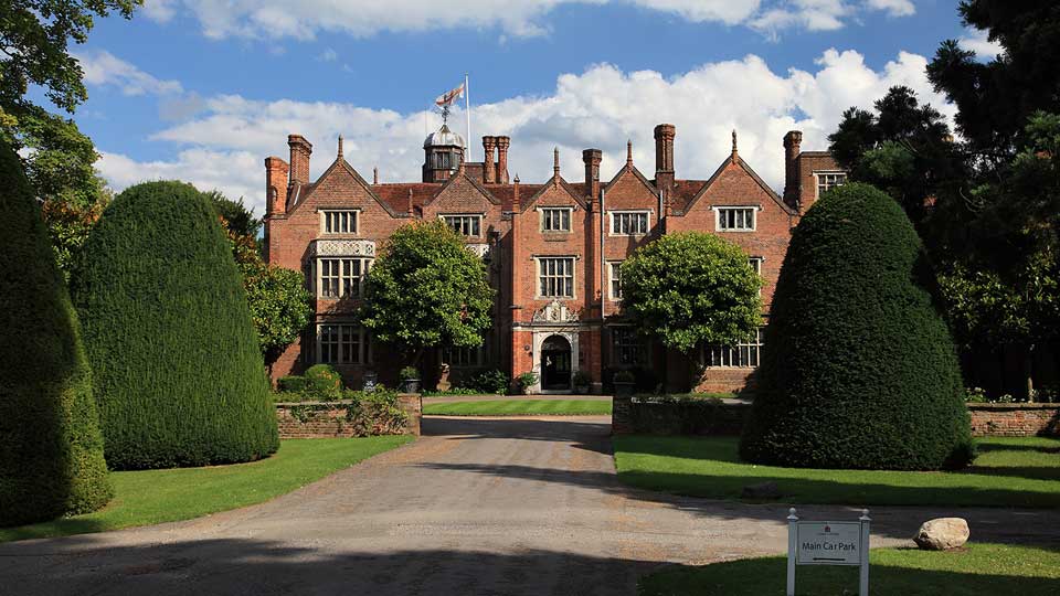 a large brick building with a flag on top