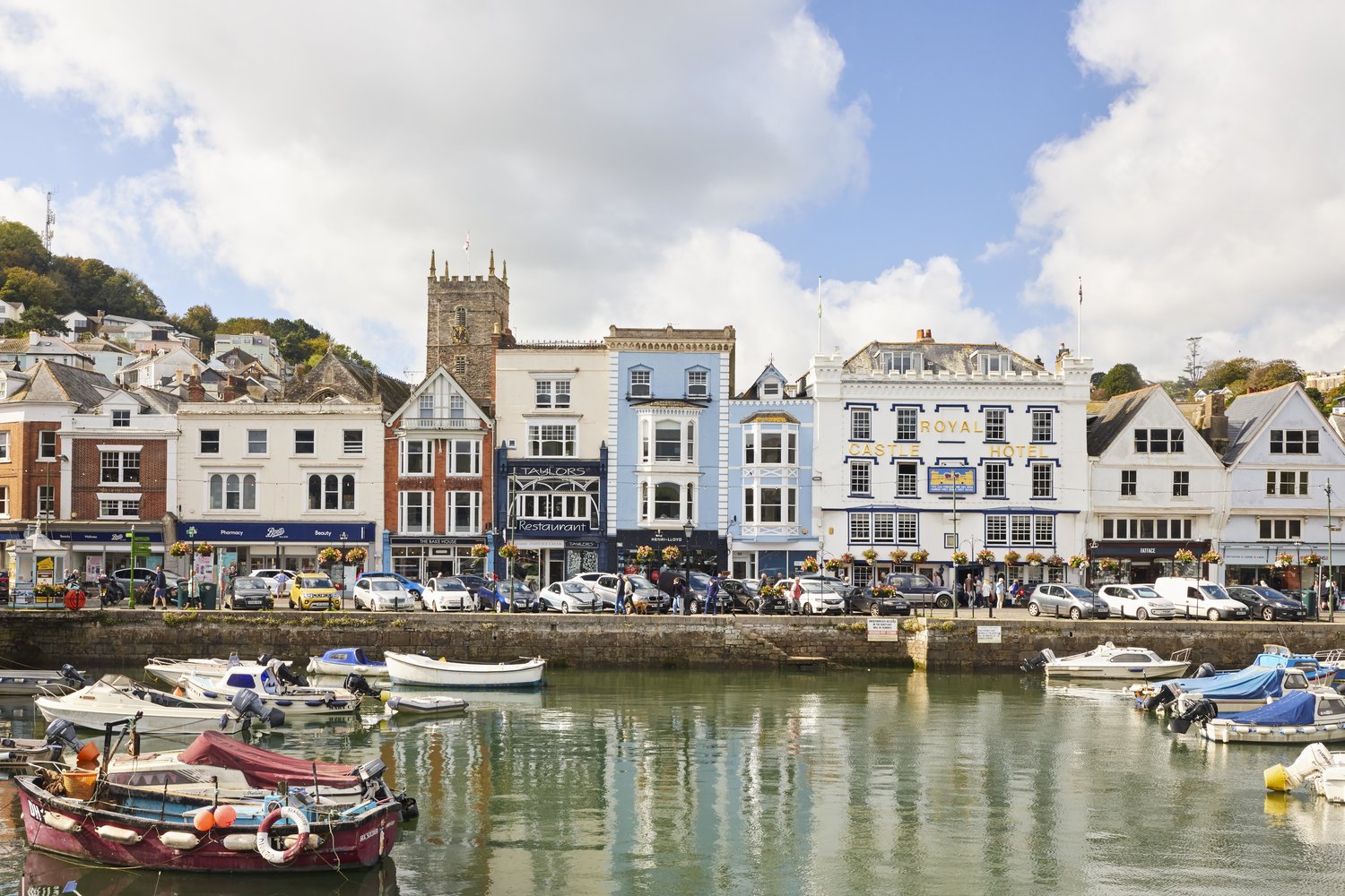 The harbour in Dartmouth with a range of shops and cafes in the background